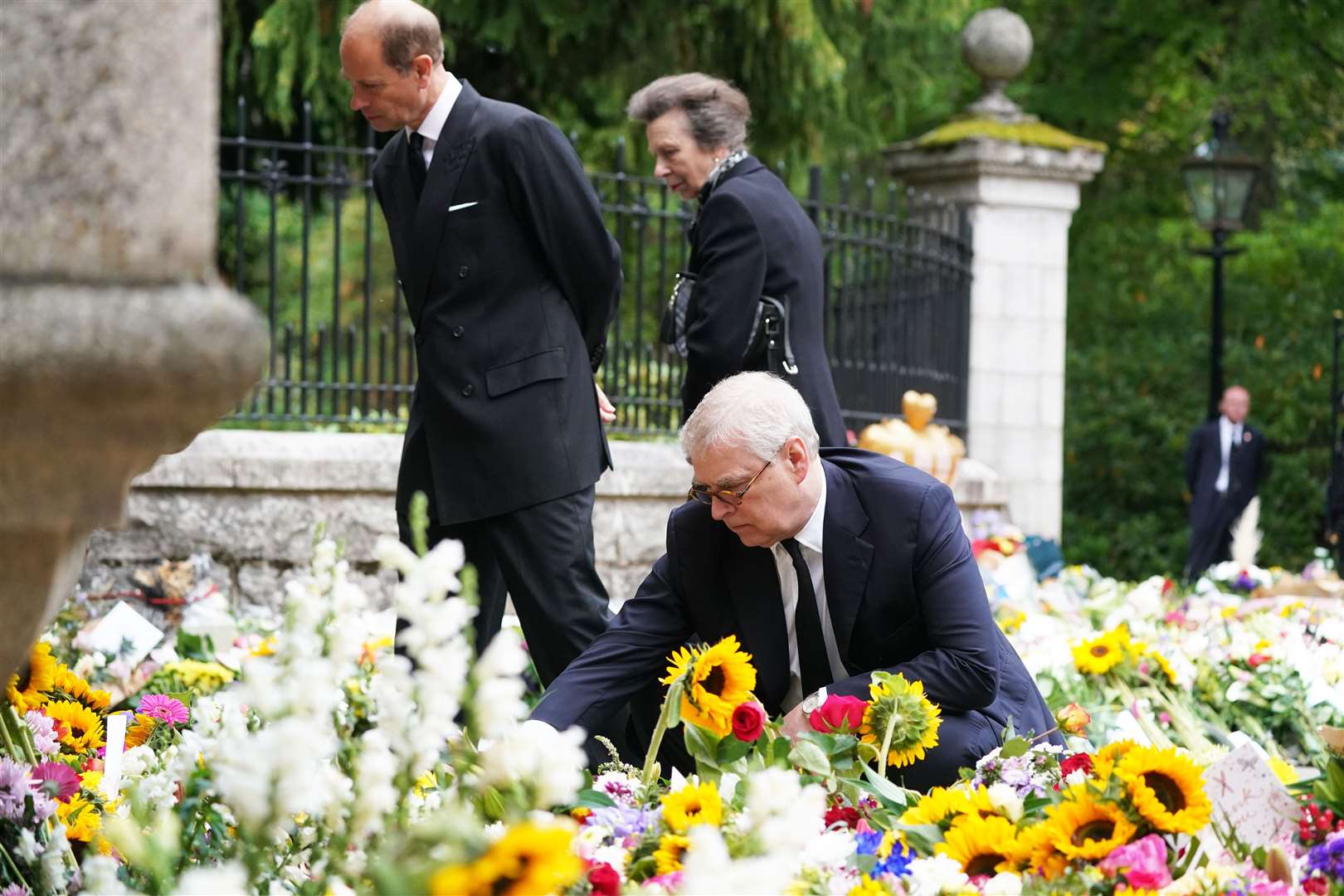 The Duke of York, Earl of Wessex and Princess Royal view the messages and floral tributes left by members of the public outside Balmoral Castle (Owen Humphreys/PA)