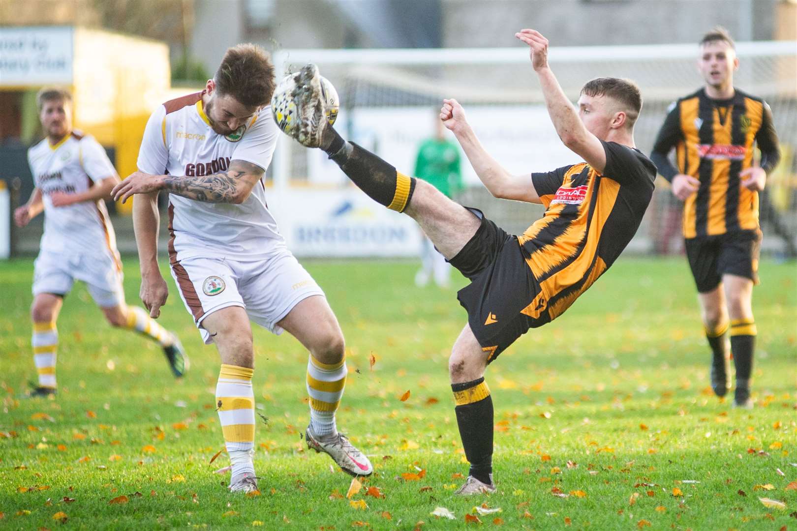 A high boot from Huntly's Reece McKeown as he competes against Forres' Martin Groat. Picture: Daniel Forsyth..