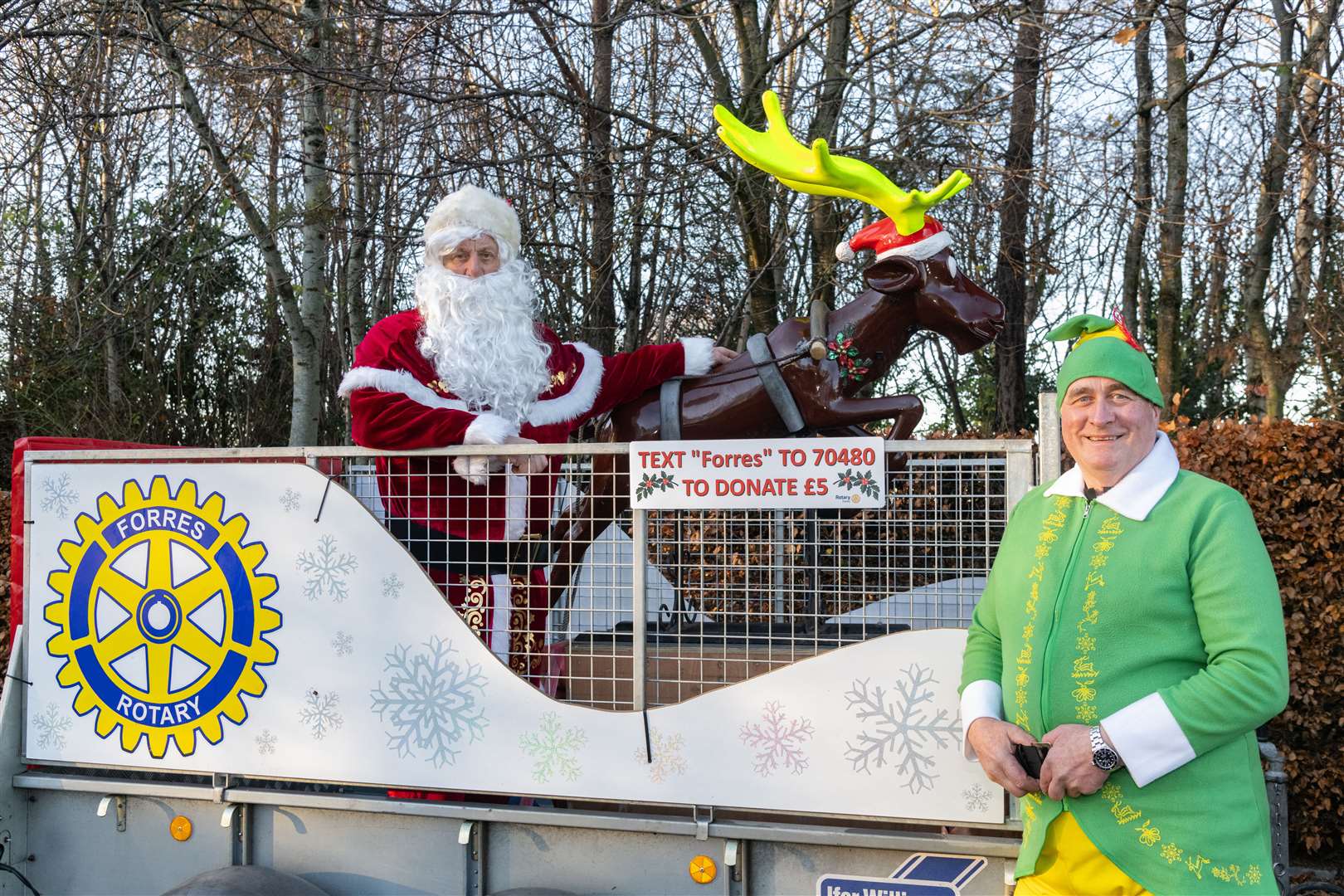 Santa and his chief elf Buddy with the sleigh.