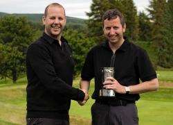 Winner of the 372-hole Scratch Championship, Mark Jones receives his trophy from Forres Golf Club captain Allan Martin