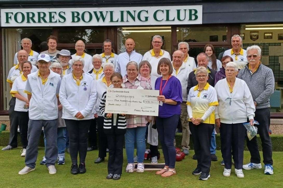 Tara Englemann from the Quarriers receives a cheque from Forres Bowling Club.