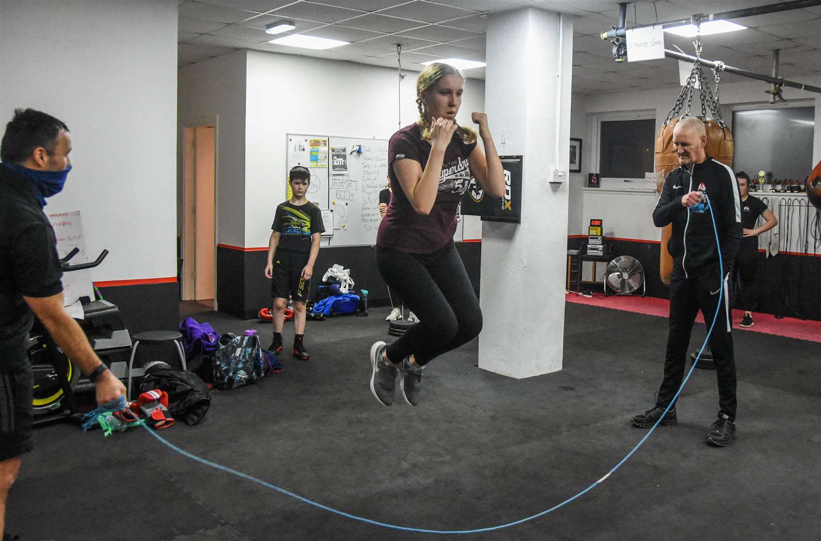 Elgin Boxing Club coaches Paul Gordon (left) and Iain Goldie put Forres girl Rona Clark through her paces on the skipping rope. Picture: Becky Saunderson..