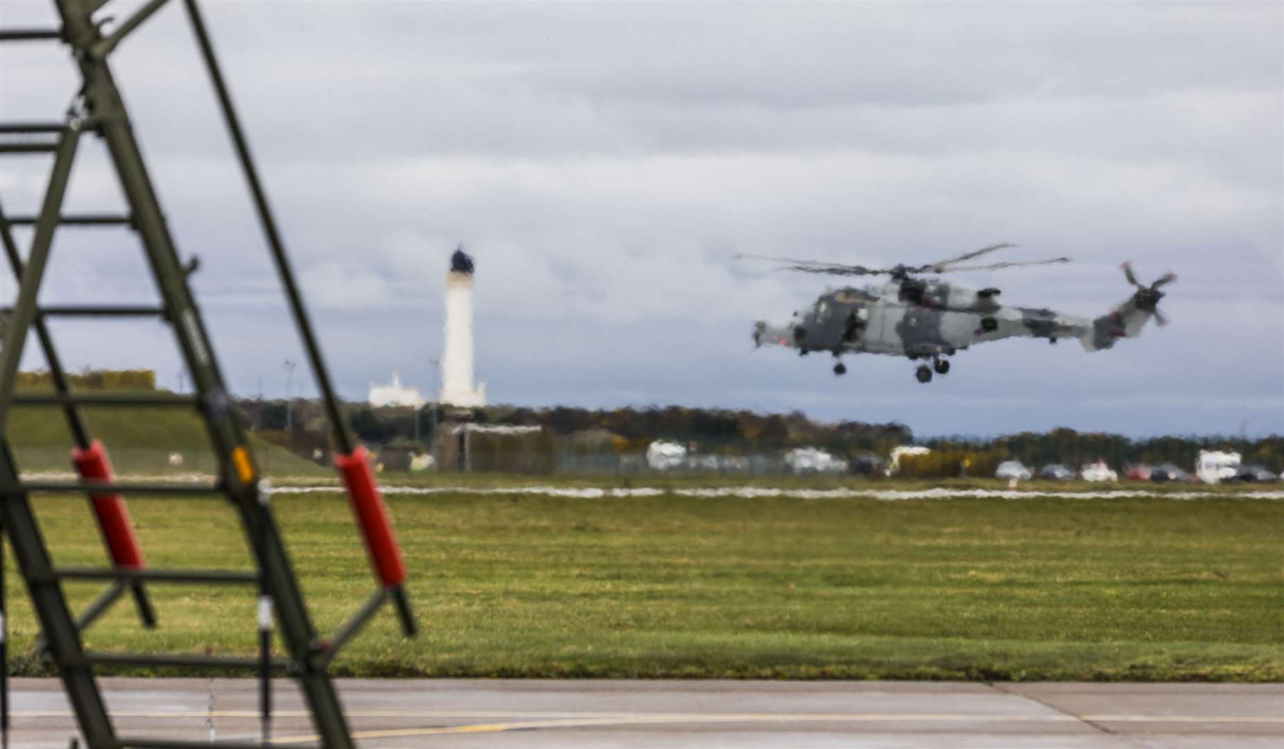 Image shows a Royal Navy Wildcat Helicopter lost in the eflux of a taxiing Typhoon at RAF Lossiemouth, 4th Apr 2019. The Wildcats of 847 Naval Air Squadron are at RAF Lossiemouth as part Ex JOINT WARRIOR, the largest Tri-service exercise also including other nations. Originator: WO 1 Sqn Section: 1 Sqn Ext: 6361 *For more information contact Photographic Section, RAF Lossiemouth, IV31 6SD. Tel: 01343 817191