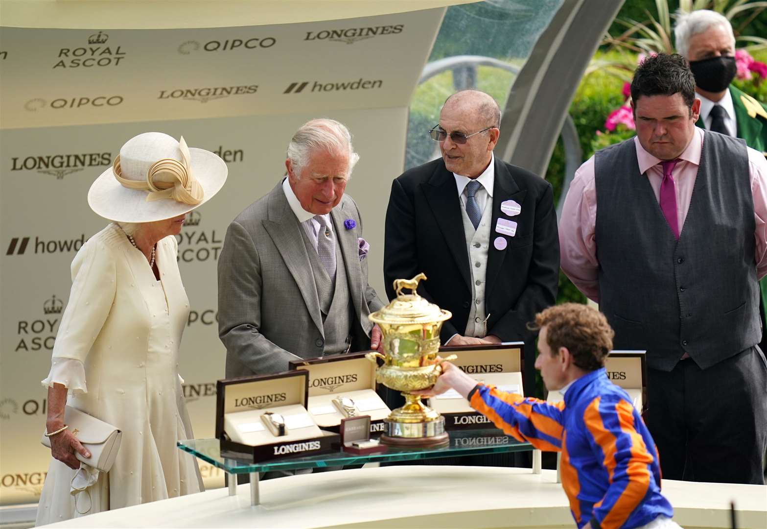 Jockey Ryan Moore collects the trophy from the Prince of Wales and the Duchess of Cornwall after winning the Prince Of Wales’s Stakes on Love (Andrew Matthews/PA)