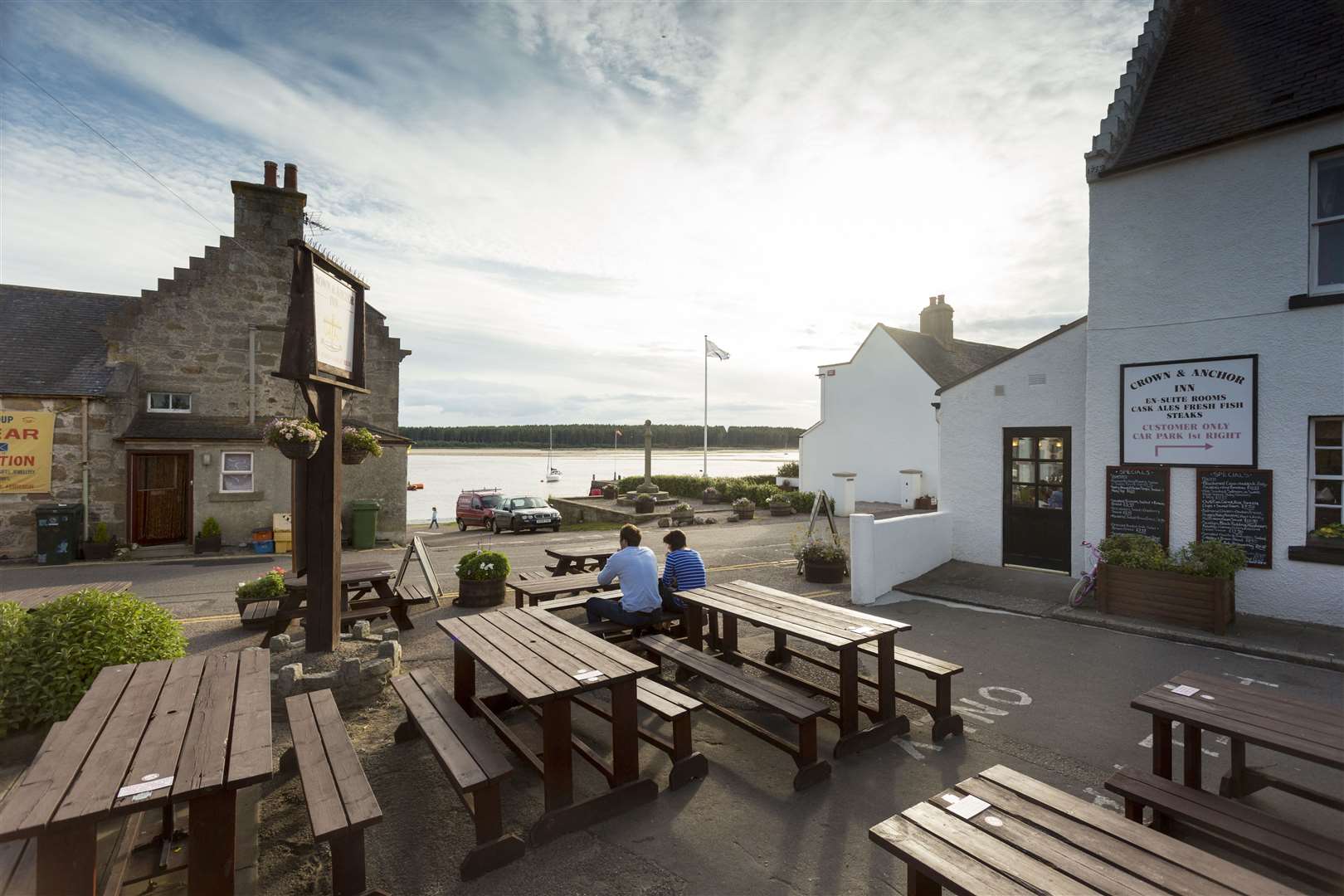 A couple sitting at the outdoor tables of the Crown and Anchor Inn, Findhorn, Moray. .Picture Credit : Paul Tomkins/ VisitScotland.