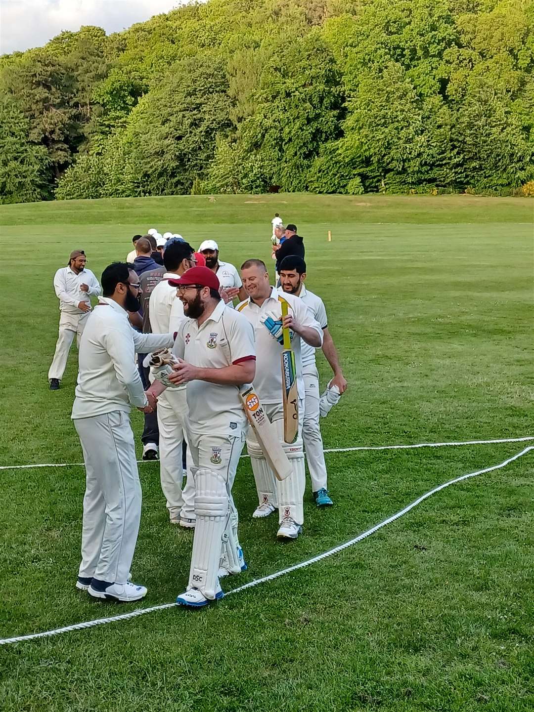 Gus Farr is congratulated on his batting performance.