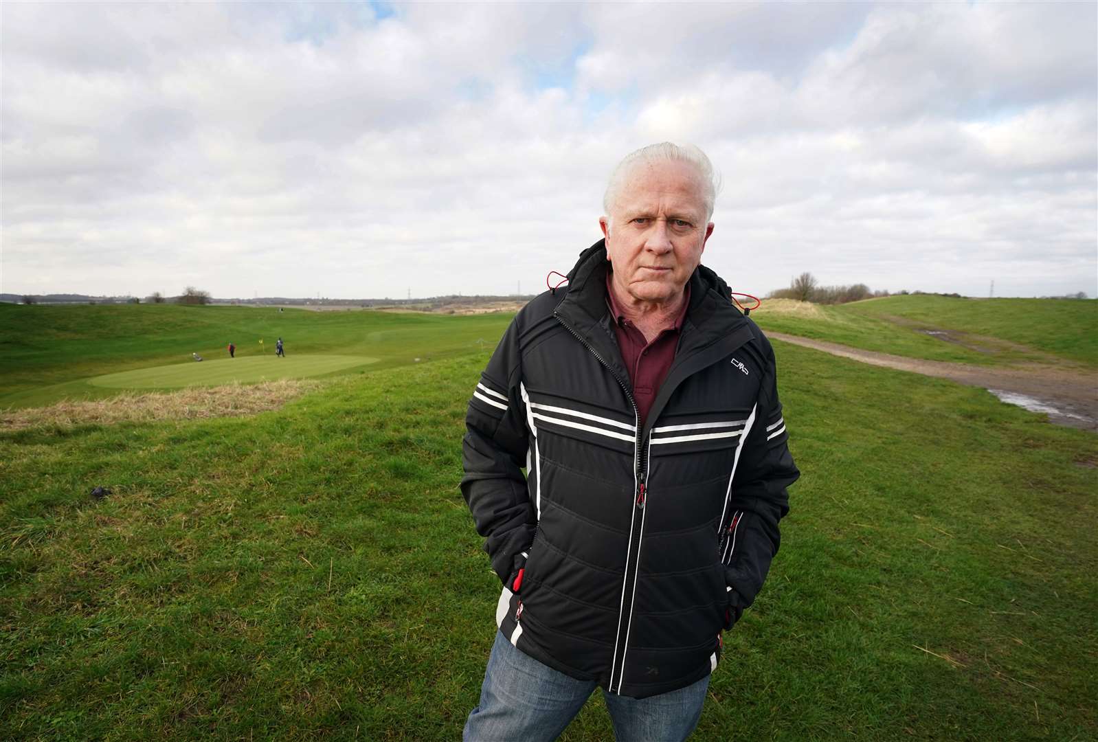 Parish councillor Vince Robson stands at the site of a proposed garden city development at Pedham Place Golf Course (Gareth Fuller/PA)
