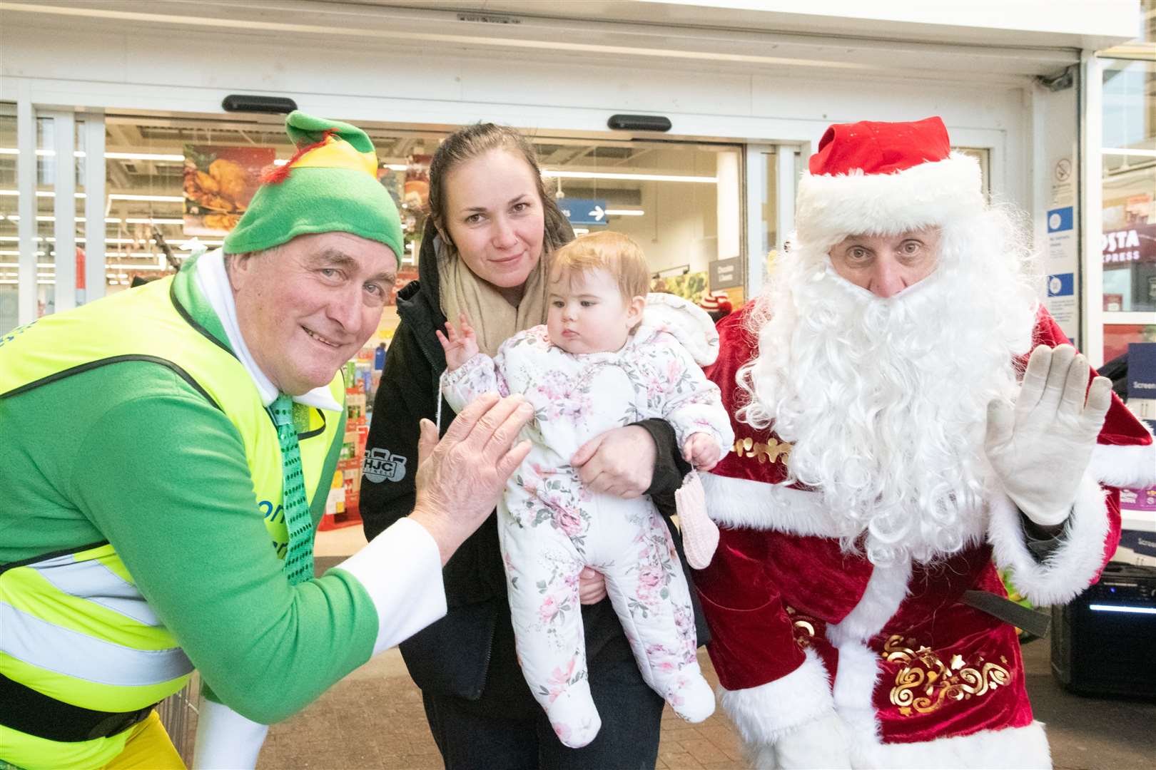 Jemma Wright and daughter Ariyah with Santa and elf Donnie.