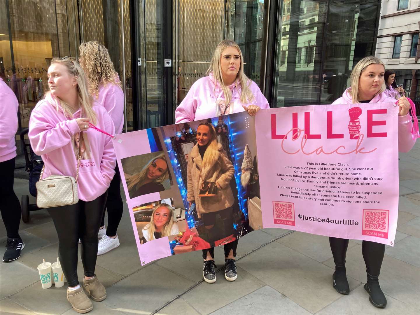 Friends of Lillie Clack, left to right, Kiera Clark, Serena Keogh and Lauren Curson, dressed in pink and holding a poster with pictures of Ms Clack on it, during a protest outside the Old Bailey in central London (Emily Pennink/PA)