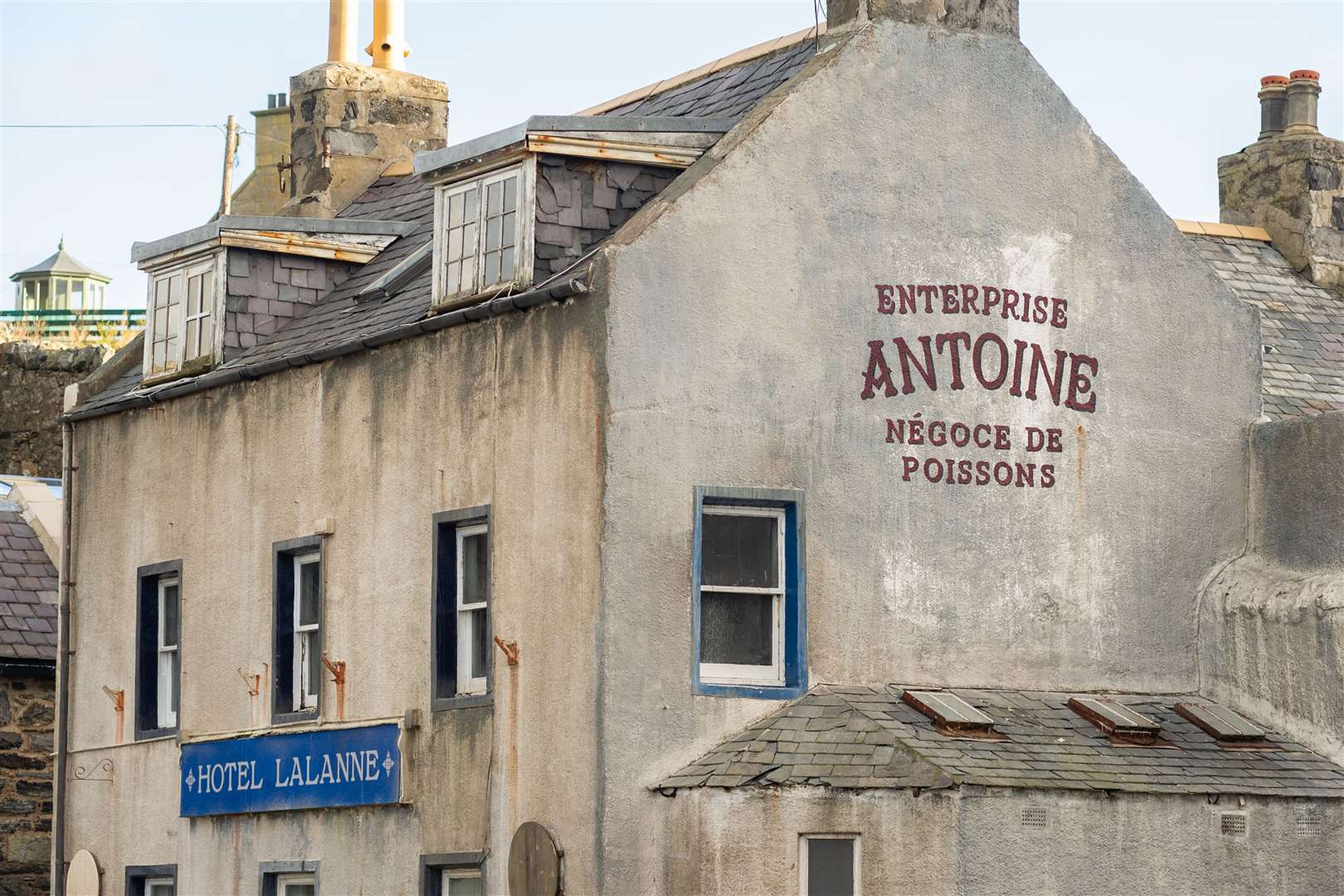 The Shore Inn has been renamed 'Hotel Lalanne' and painted in a murky white colour. It also has a French logo added to the side of the building which says 'Enterprise Antoine Negoce de Poissons'...The area around the harbour in Portsoy undergoes a transformation ahead of the filming of Peaky Blinders... Picture: Daniel Forsyth..