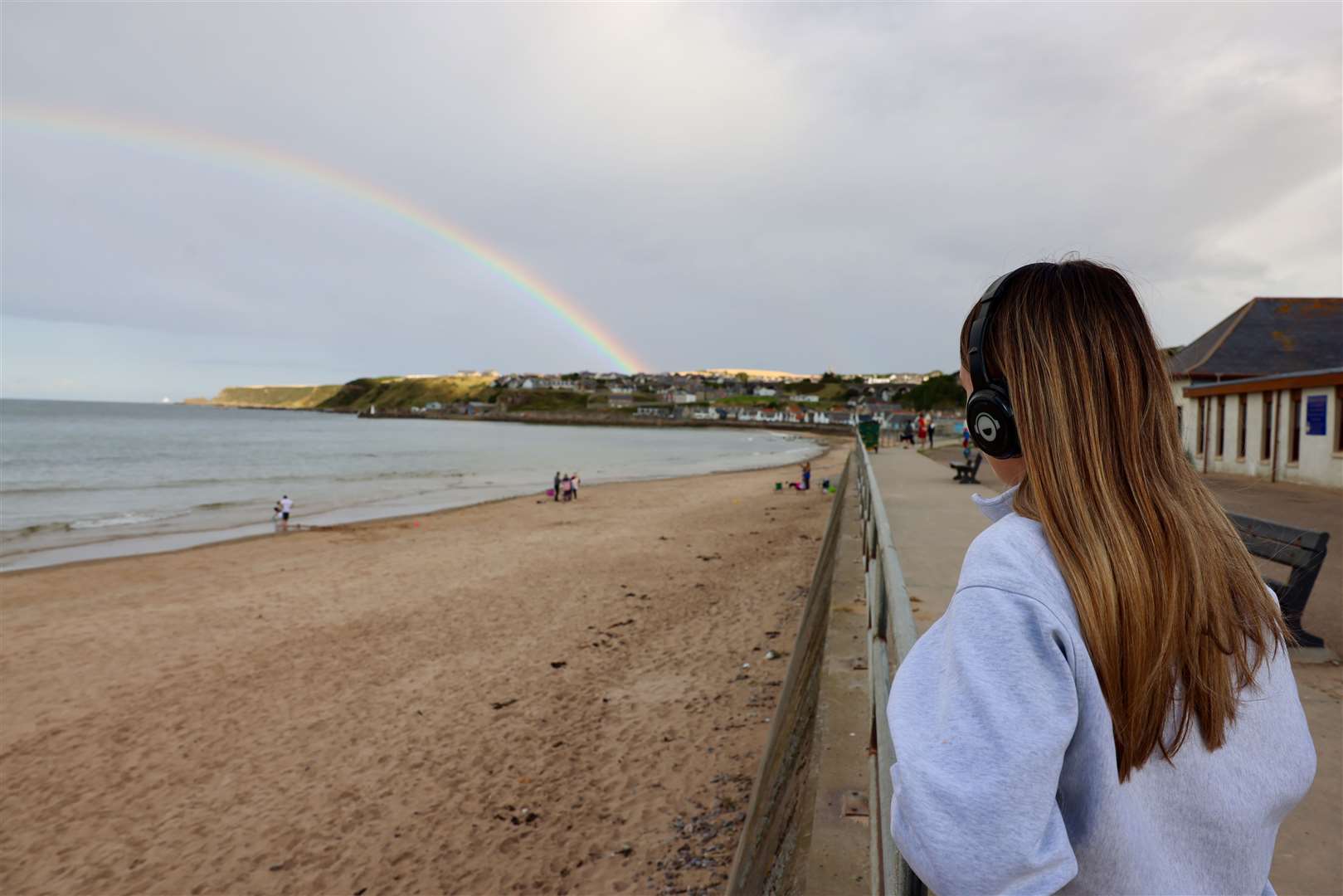 A fantastic rainbow in the sky above Cullen as this girl listens. Picture: Graeme Roger (Wildbird)