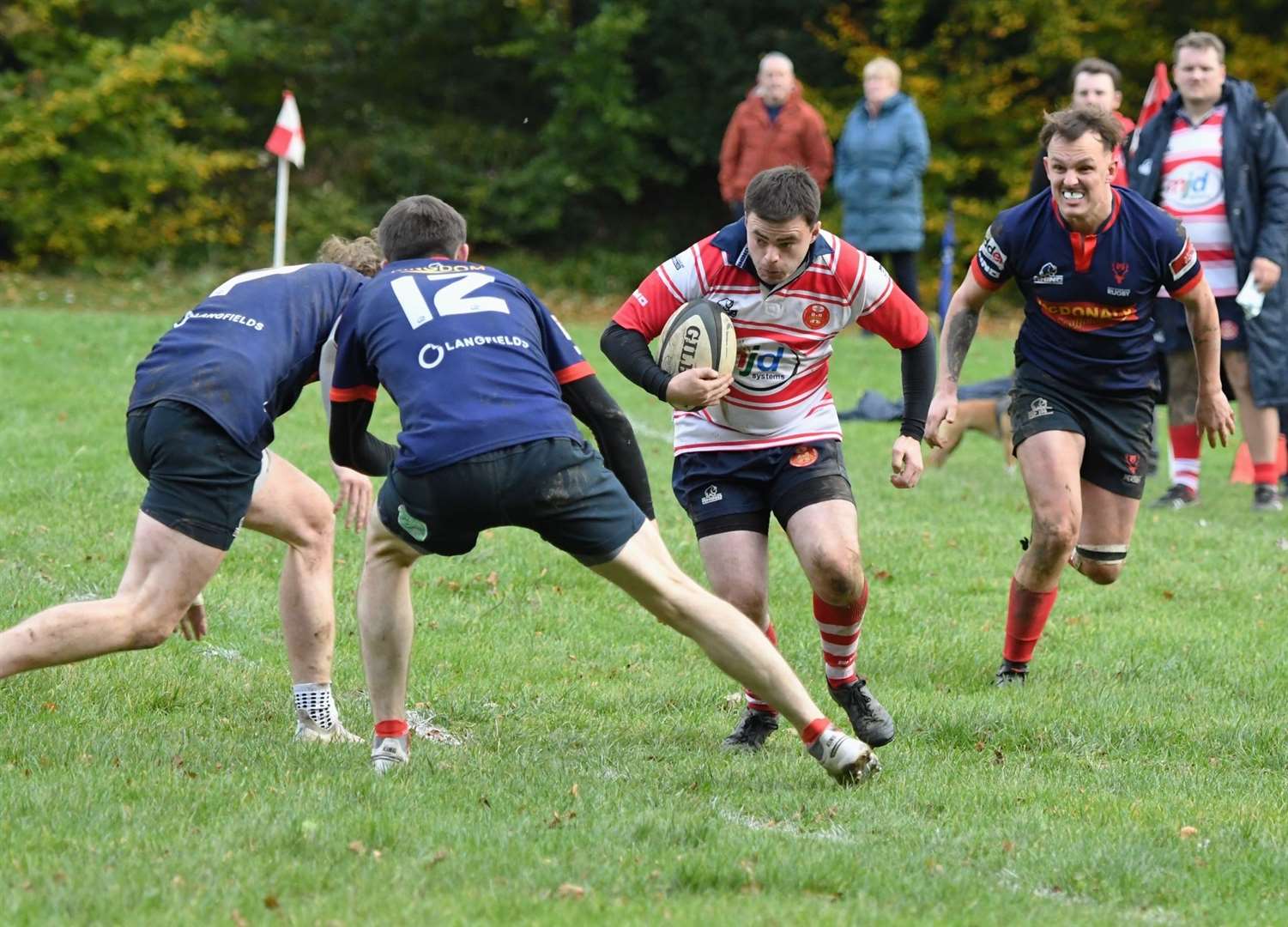 Lewis Hogg looks to take contact from two defenders. Photo: James Officer
