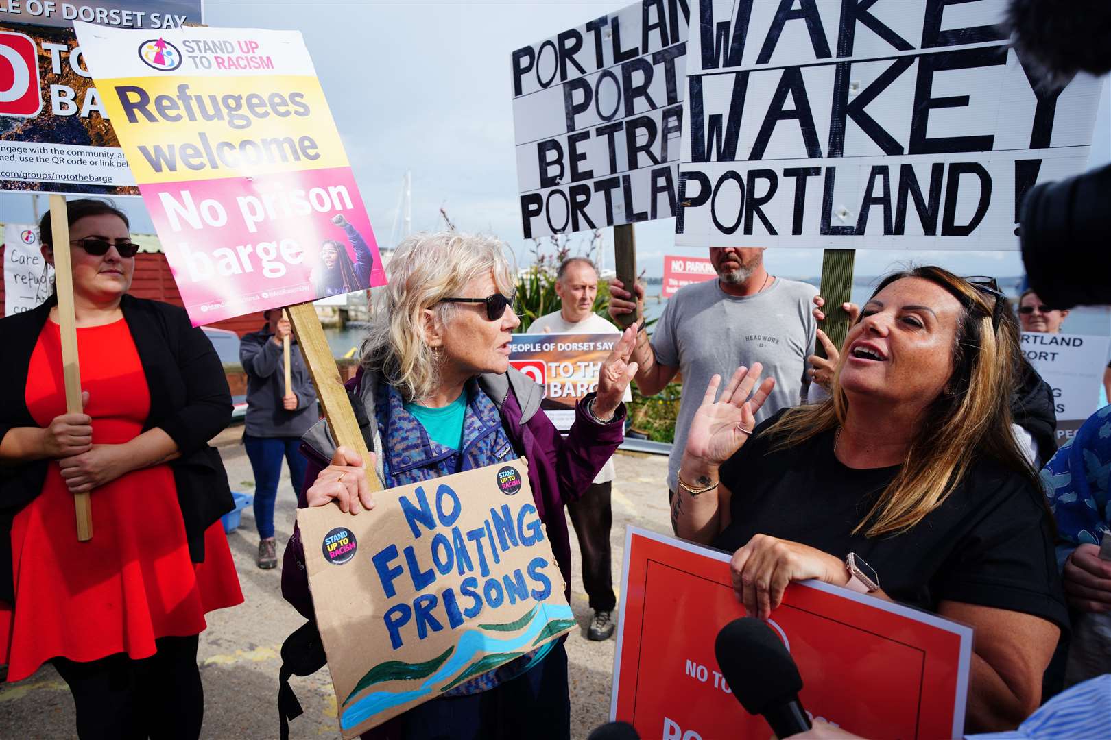 Rival protesters argue in Portland in Dorset after the Bibby Stockholm accommodation barge arrived (Ben Birchall/PA)