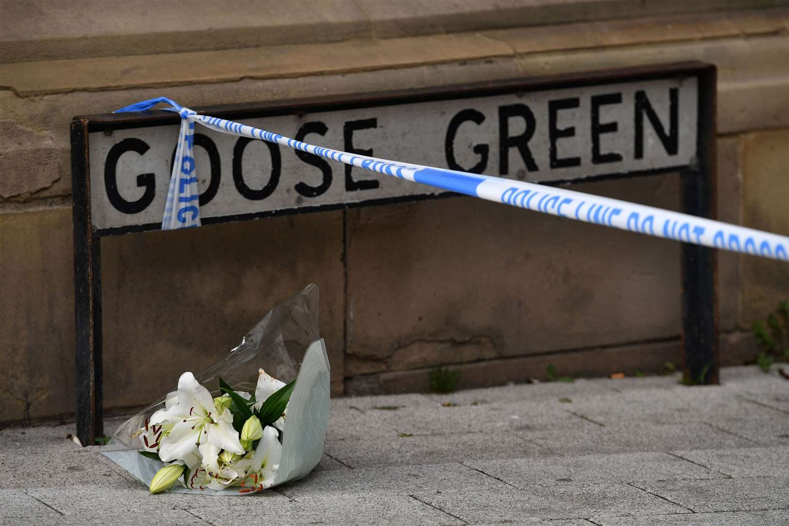 A lone floral tribute at the scene in Railway Street in the Goose Green area of Altrincham (PA)