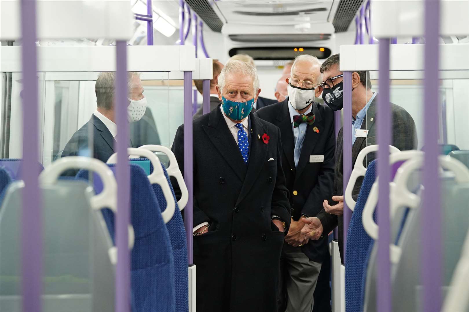 Charles is given a tour of a battery powered train (Jane Barlow/PA)
