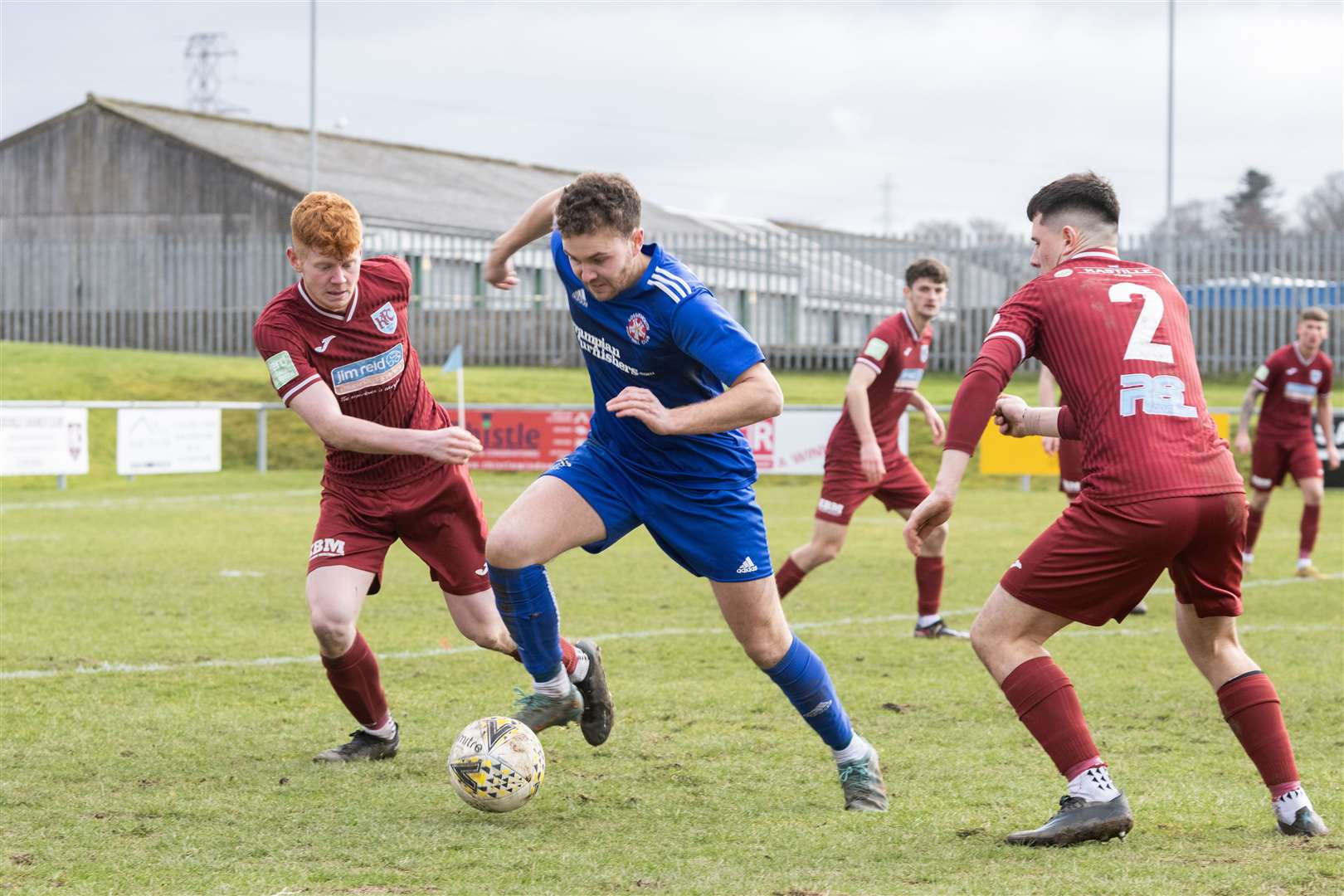 Lossie's Ryan Stuart breaks through against Keith's Matthew Tough and Connor Killoh. ..Keith F.C v Lossiemouth F.C, Kynoch Park...Picture: Beth Taylor.
