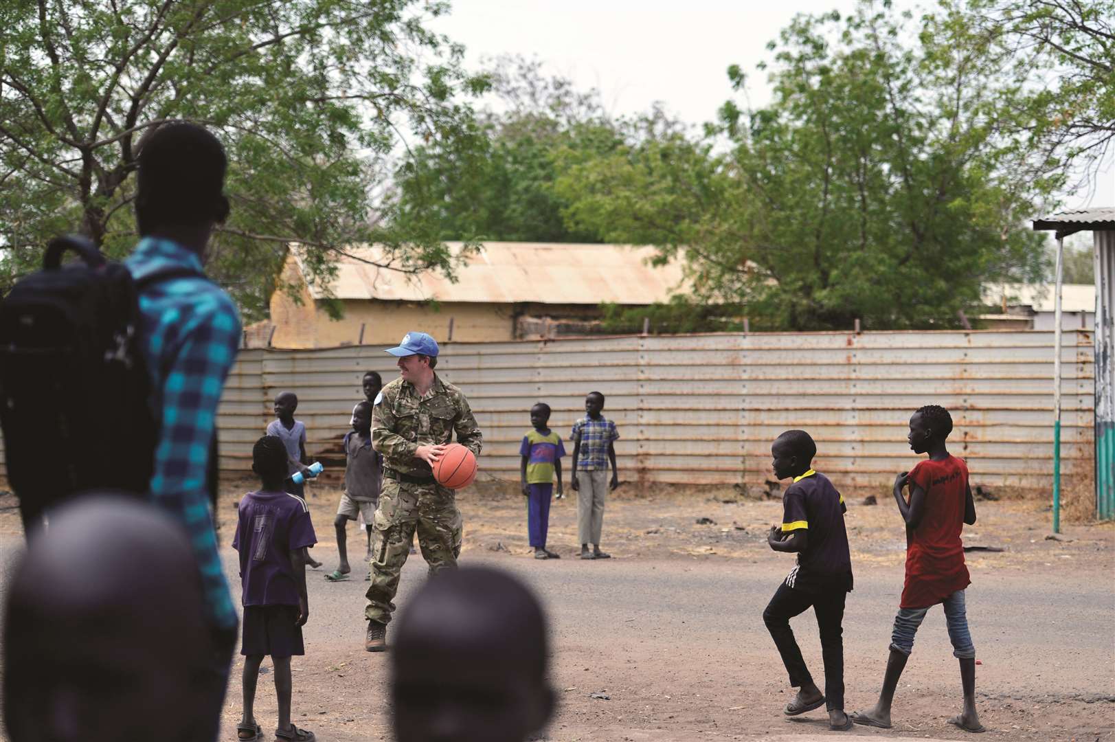 Captain Wearmouth playing with local children during the Civil Military vocational training.