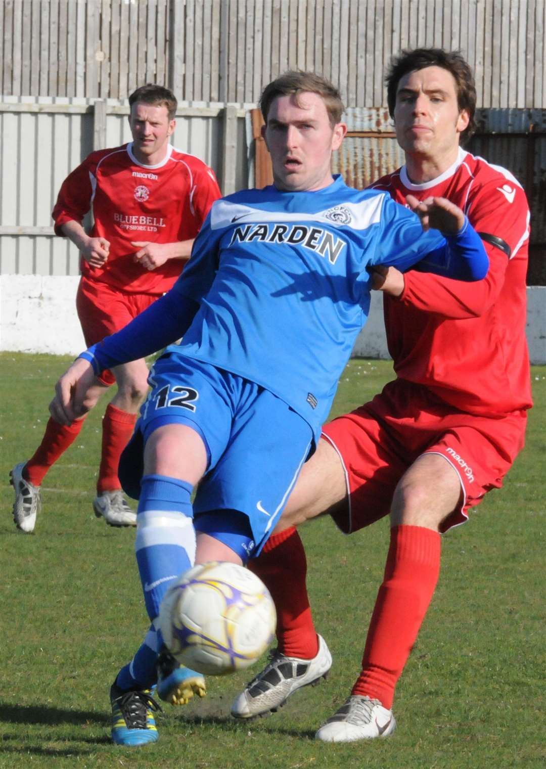 Sam Milton (right) in action during his footballing days with Lossiemouth.