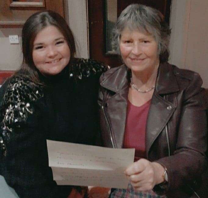 Lorna and her daughter Ashleigh Murdoch opening the letter of award.