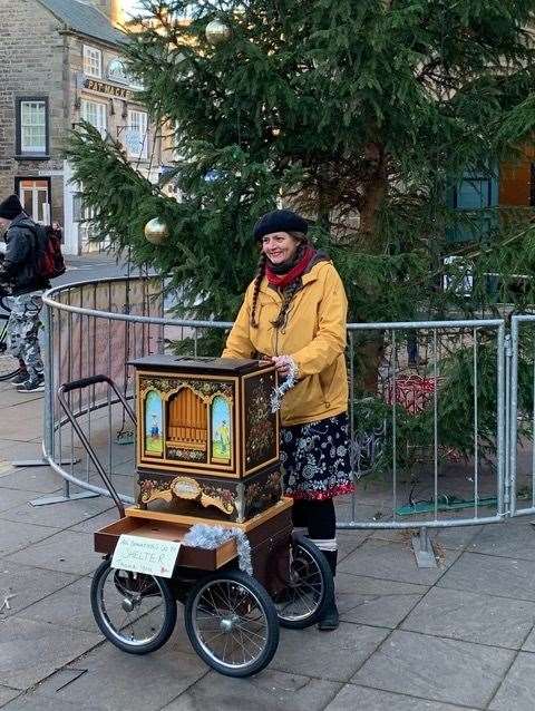 Maria Start cranks up the sounds beneath the Christmas tree outside the Tolbooth to the delight of Christmas shoppers and passers-by.