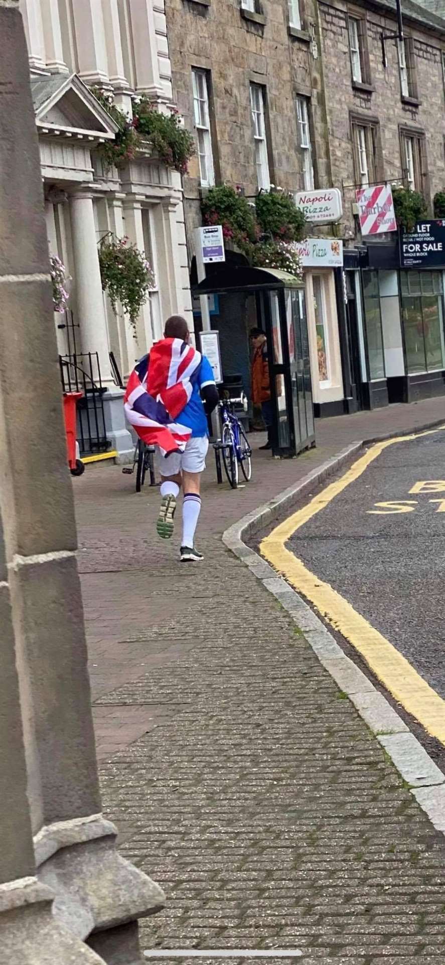 Kye parading the red, white and blue of Rangers through the high street.