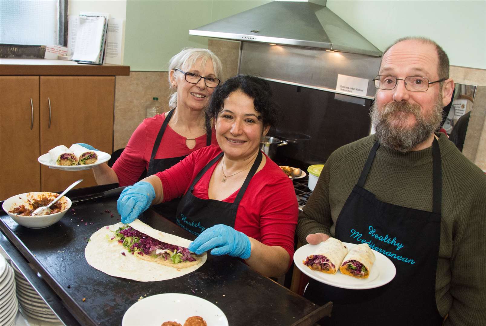 Wendy Robertson, Medine Duff and Eddie Duff serving and preparing food for the Mediterranean pop-up cafe.