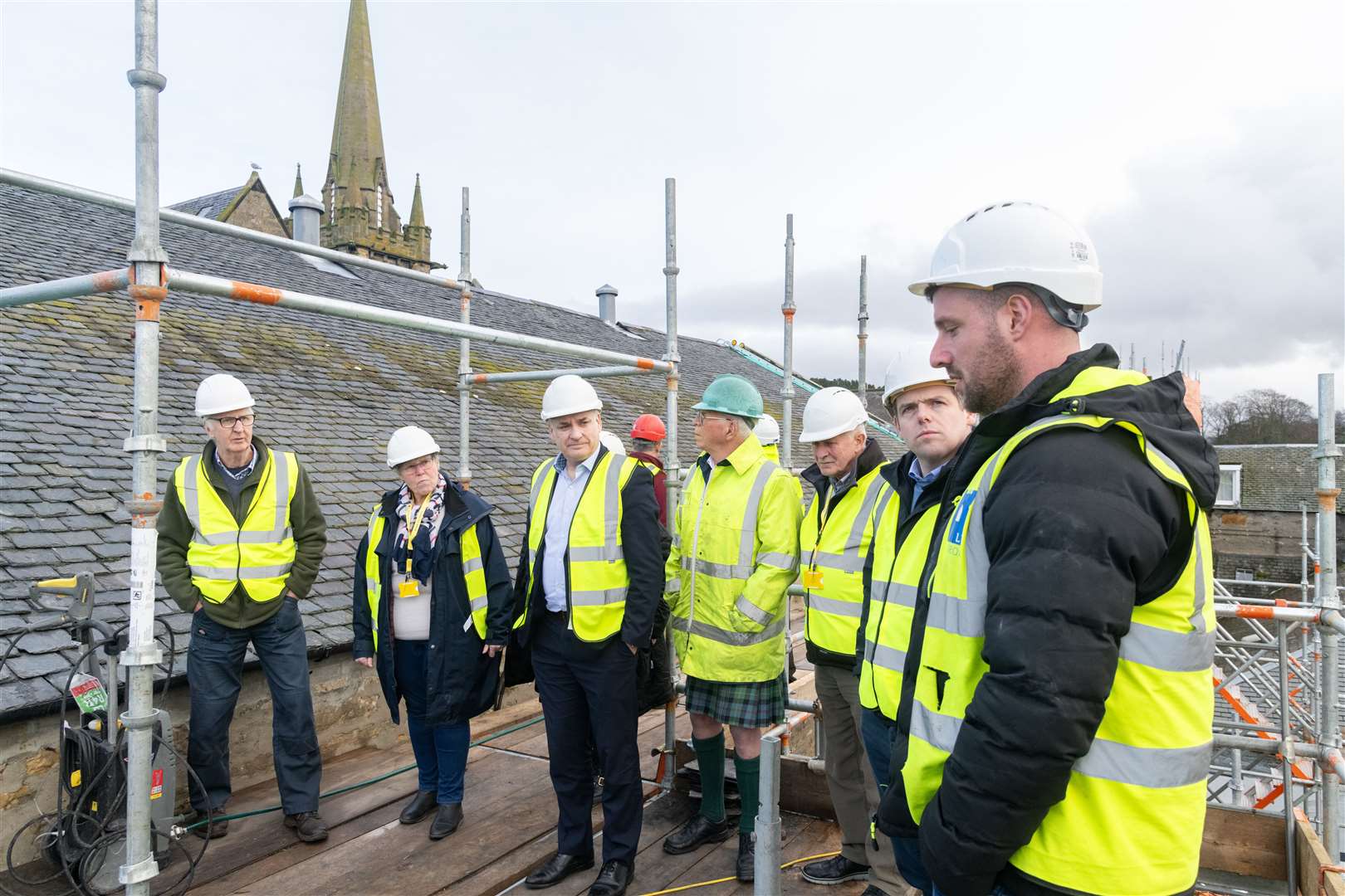The group were guided around the insulation works at the top of the building.