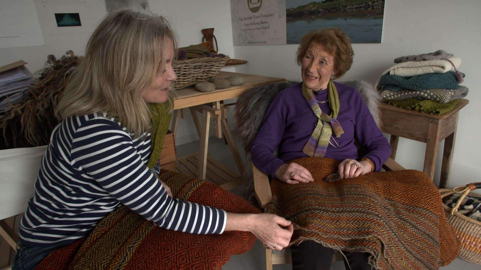 Meg and Jean Rodgers examine different samples of fabric.