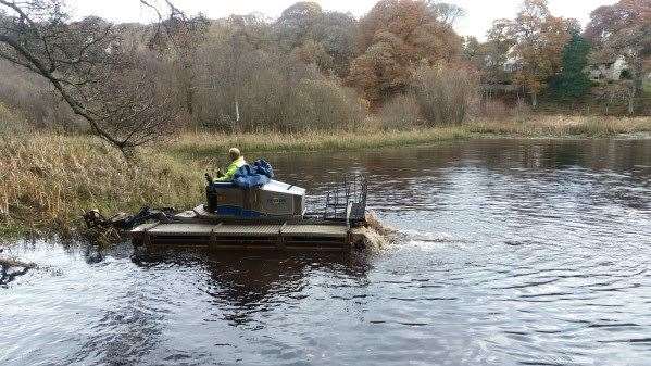 The specialist machine in operation at Sanquhar Pond, in Forres, cutting back reeds, rushes and horsetail weeds.