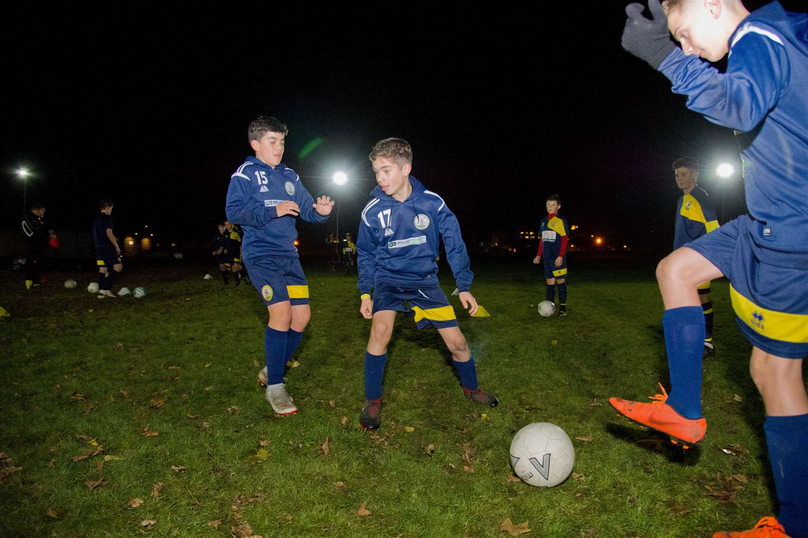 Youth players training under the club's portable floodlights.
