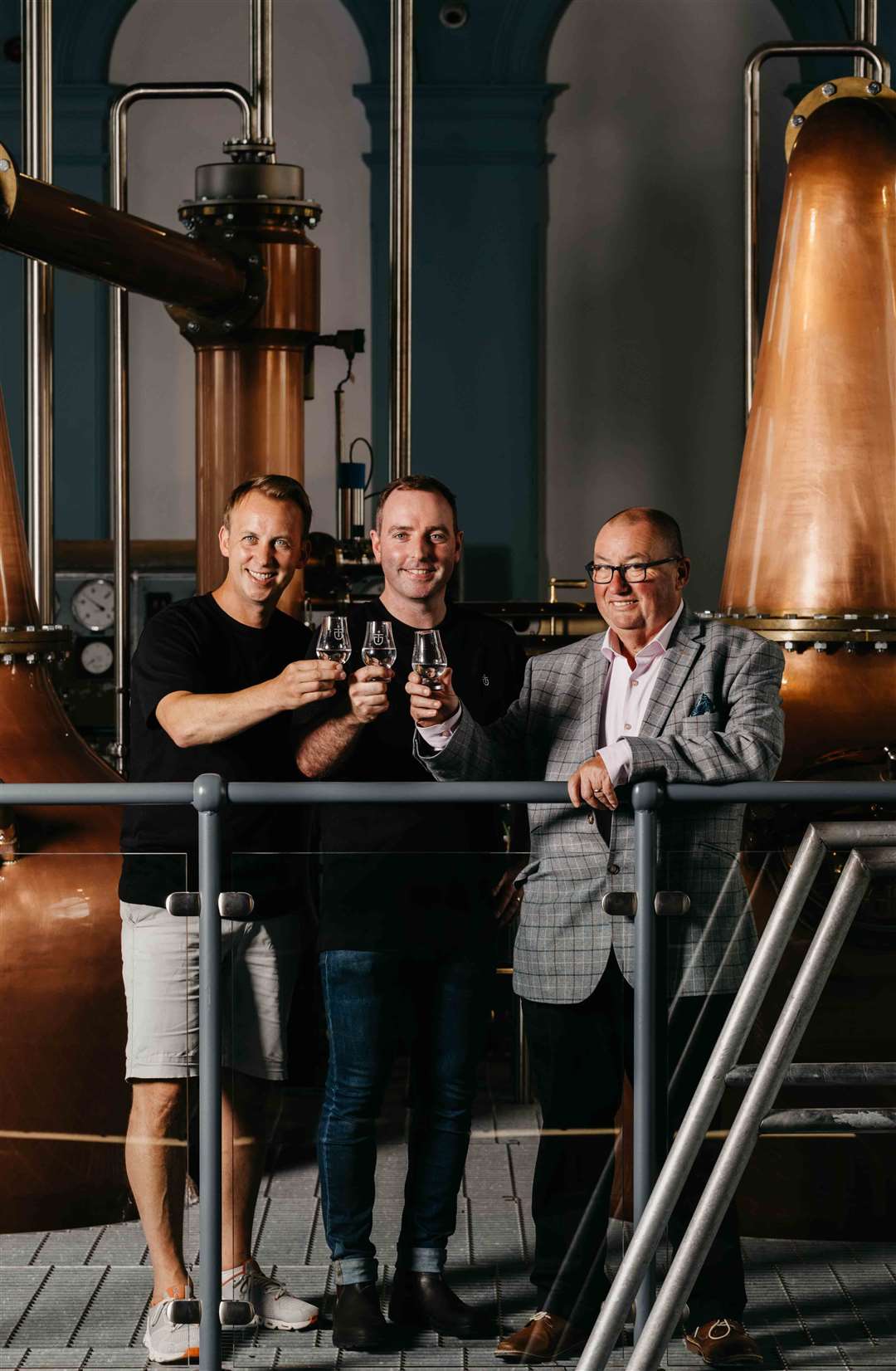 Head distiller Damien Rafferty, centre, said it was ‘an incredible feeling’ to finally begin production on site (Titanic Distillers/PA)
