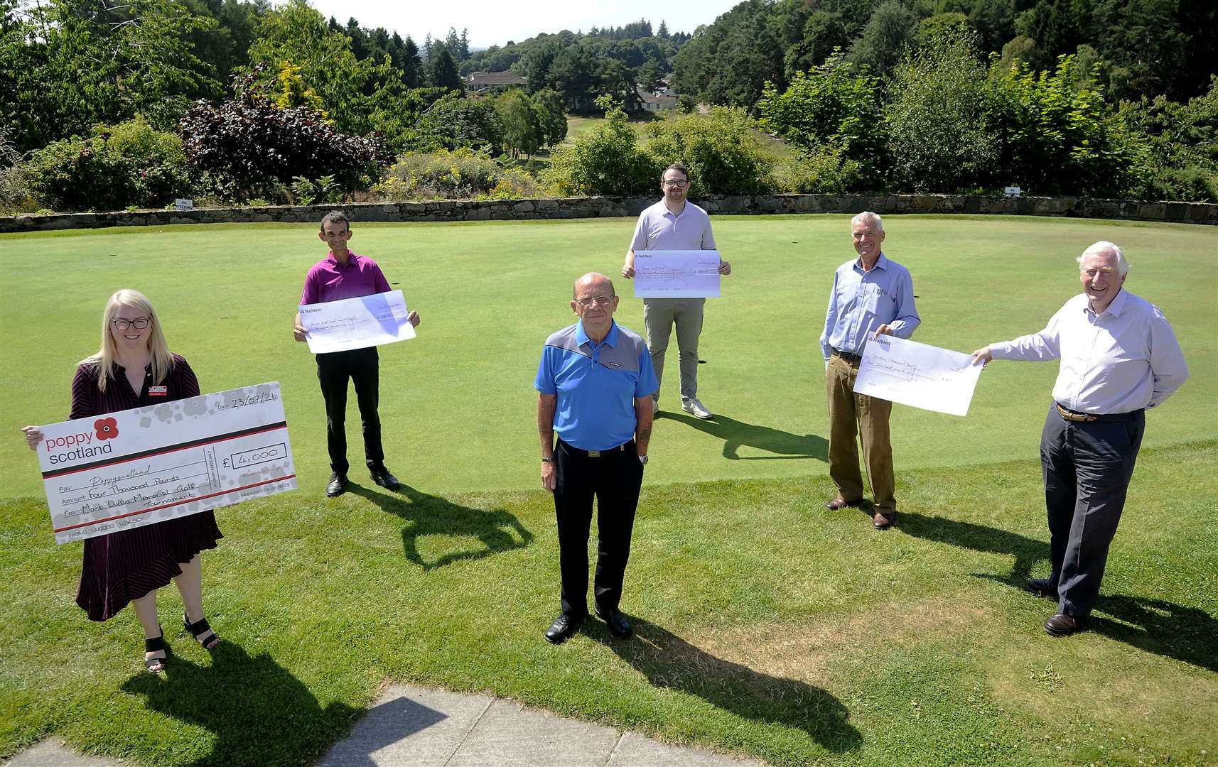 Accepting the cheques from Albert Duffus (centre) are (from left) Frances Beveridge for Poppy Scotland, Colin Mackay for Forres Junior Golfers, Sean Blacklaw for Forres Golf Club and Graham Hilditch and Seymour Monro for Erskine Leanchoil Trust.