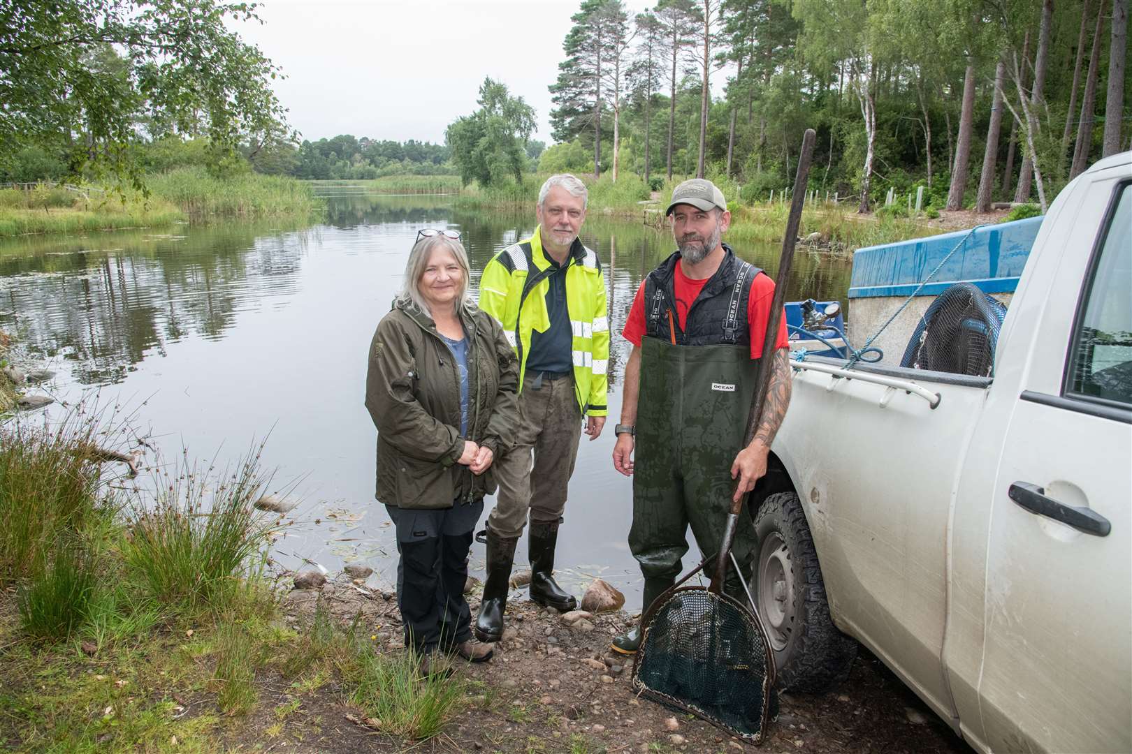 Trustees Julia Mackay and Brian Higgs with Derek Mckay from stockists Forgue Fish Farm.