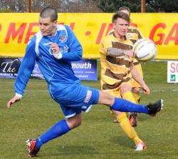 Scott Morre of Forres Mechanics clears from Jamie Lennox of Cover Rangers