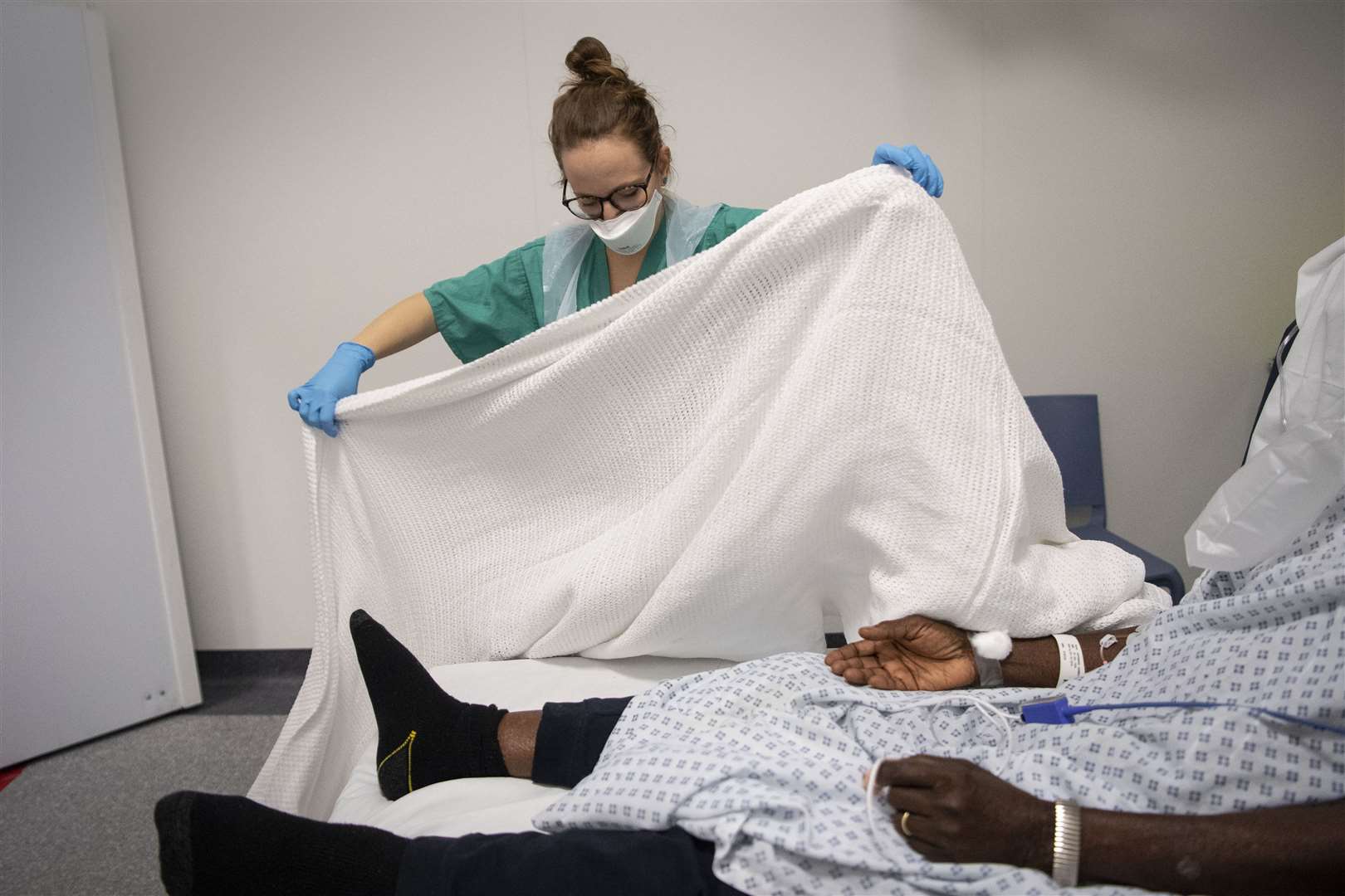 A staff nurse tends to a patient in the Emergency Department (Victoria Jones/PA)