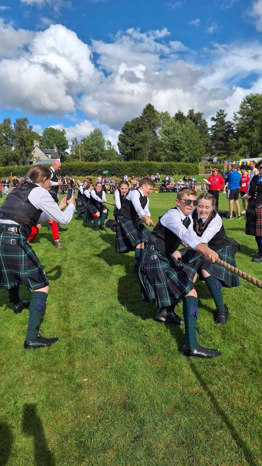 Junior members of Forres and District Pipe Band giving it their all in the tug o' war at Nethy Bridge.