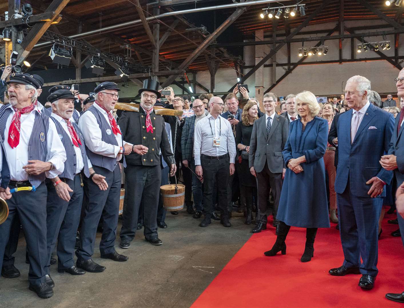 The King and the Queen Consort listen to a sea shanty group during a reception at Schuppen 52, Hamburg (Arthur Edwards/The Sun/PA)