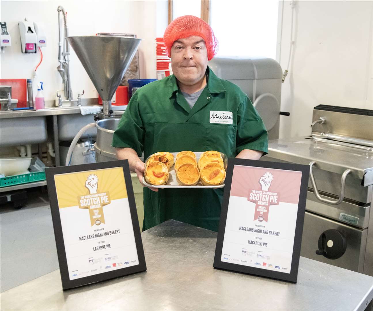 Maclean's high care charge hand Michael Baranski with the two awards the bakery won at the World Championship Scotch Pie Awards. Pictures: Beth Taylor.