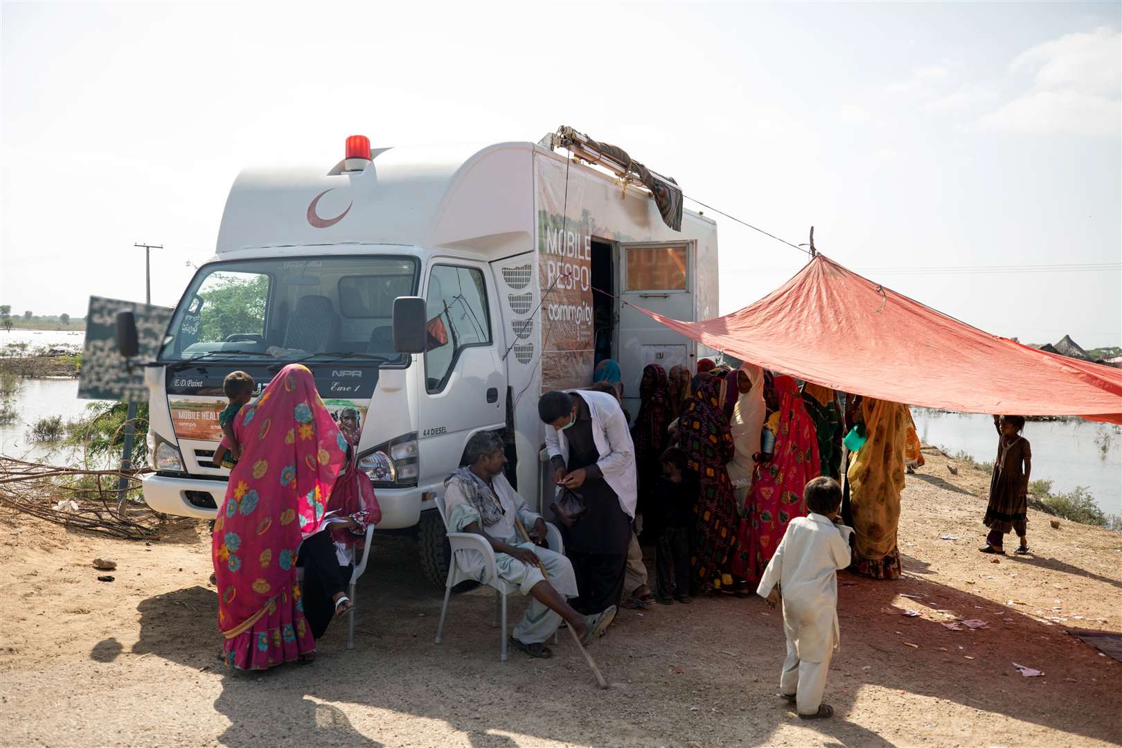 Flood survivors receive medical aid at a mobile clinic set up for flood-affected families by CAFOD in Sindh, Pakistan (Khaula Jamil/DEC/PA)