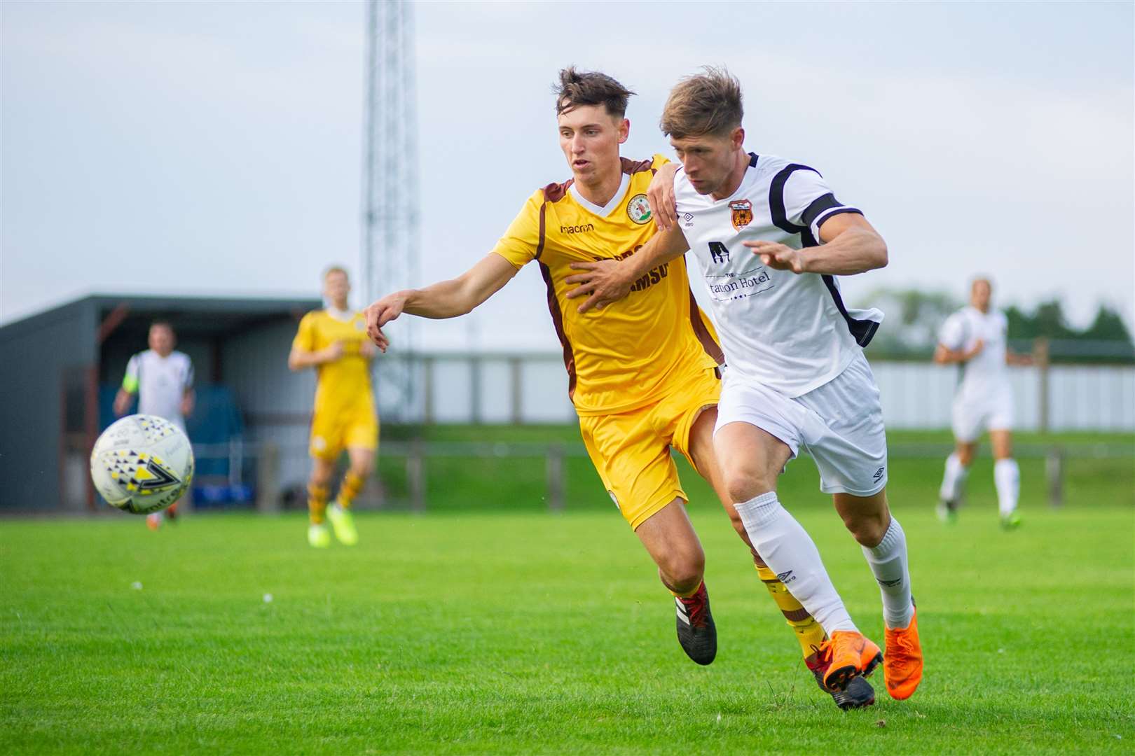 Forres Mechanics Callum Johnston competes with Rothes winger Ally Mackenzie. Picture: Daniel Forsyth
