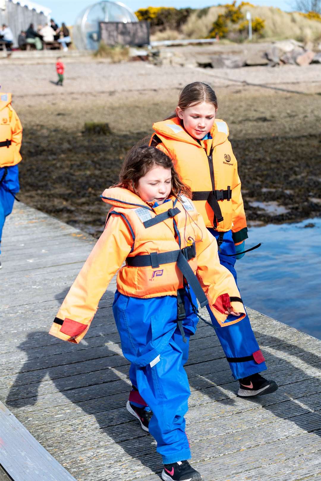 Mali Parker (8) and Scout merry (9) heading down the pontoon at Findhorn Marina to board the North 58 Sea Adventures boat for water based activities.