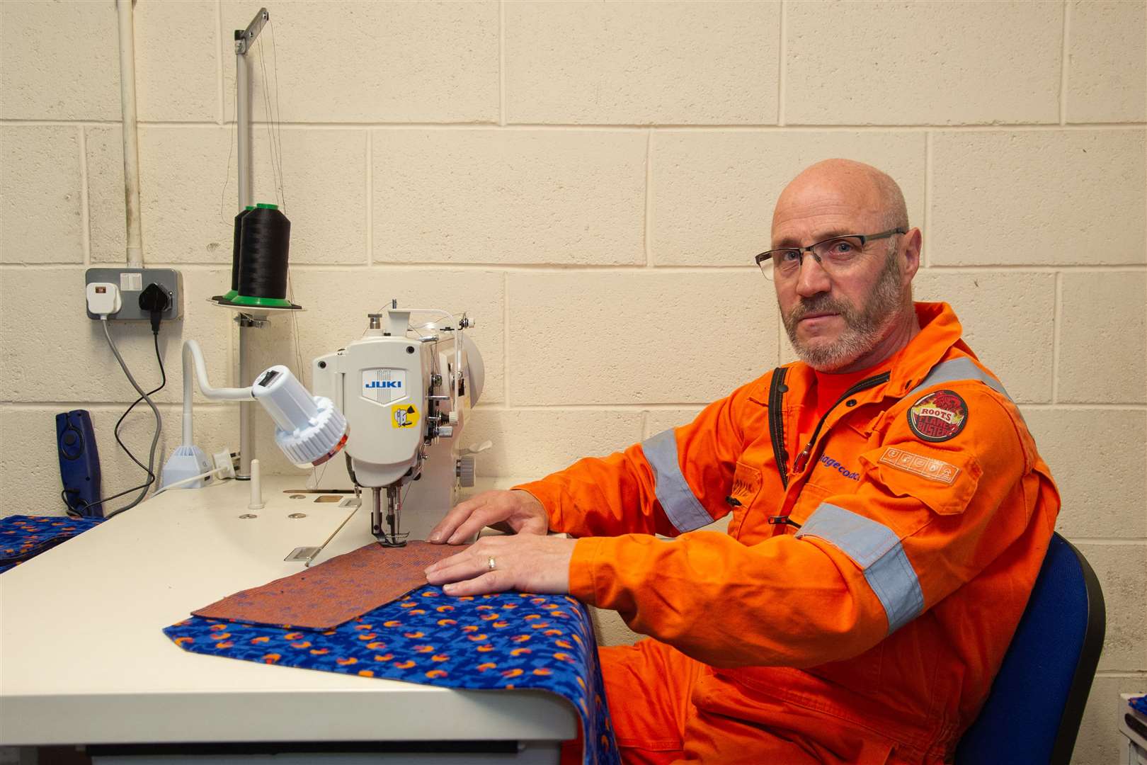 Martin Boon, from Hopeman, has been using his work skills as a Stagecoach trimmer to sew scrubs for local health workers as part of the Moray Scrubs effort. Picture: Daniel Forsyth.