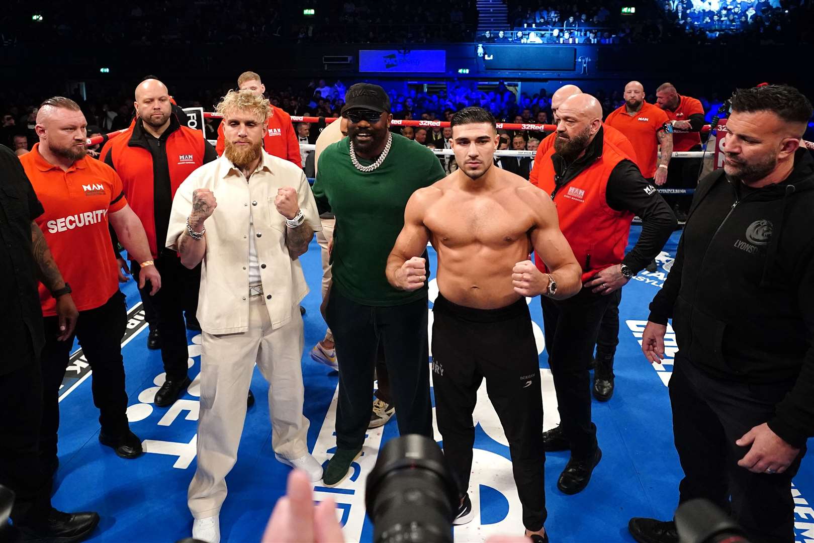 Jake Paul, left, and Tommy Fury pose after a face-off in the ring (PA)