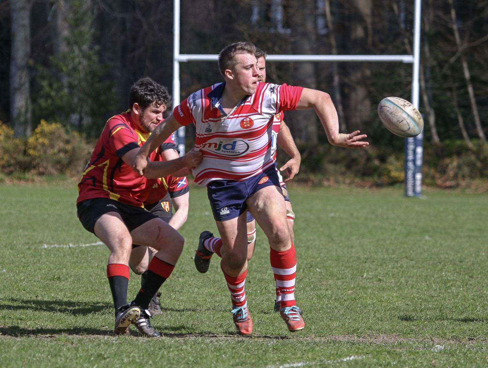 Cameron Hughes offloads in the tackle. Picture: John MacGregor