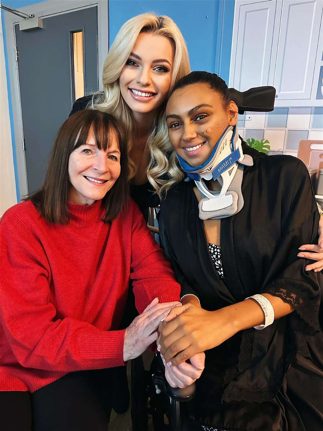 Reigning Miss World Karolina Bielawska (centre), and the chairwoman of the Miss World organisation, Julia Morley, visit Darcey Corria in hospital (Miss World Organisation/PA)