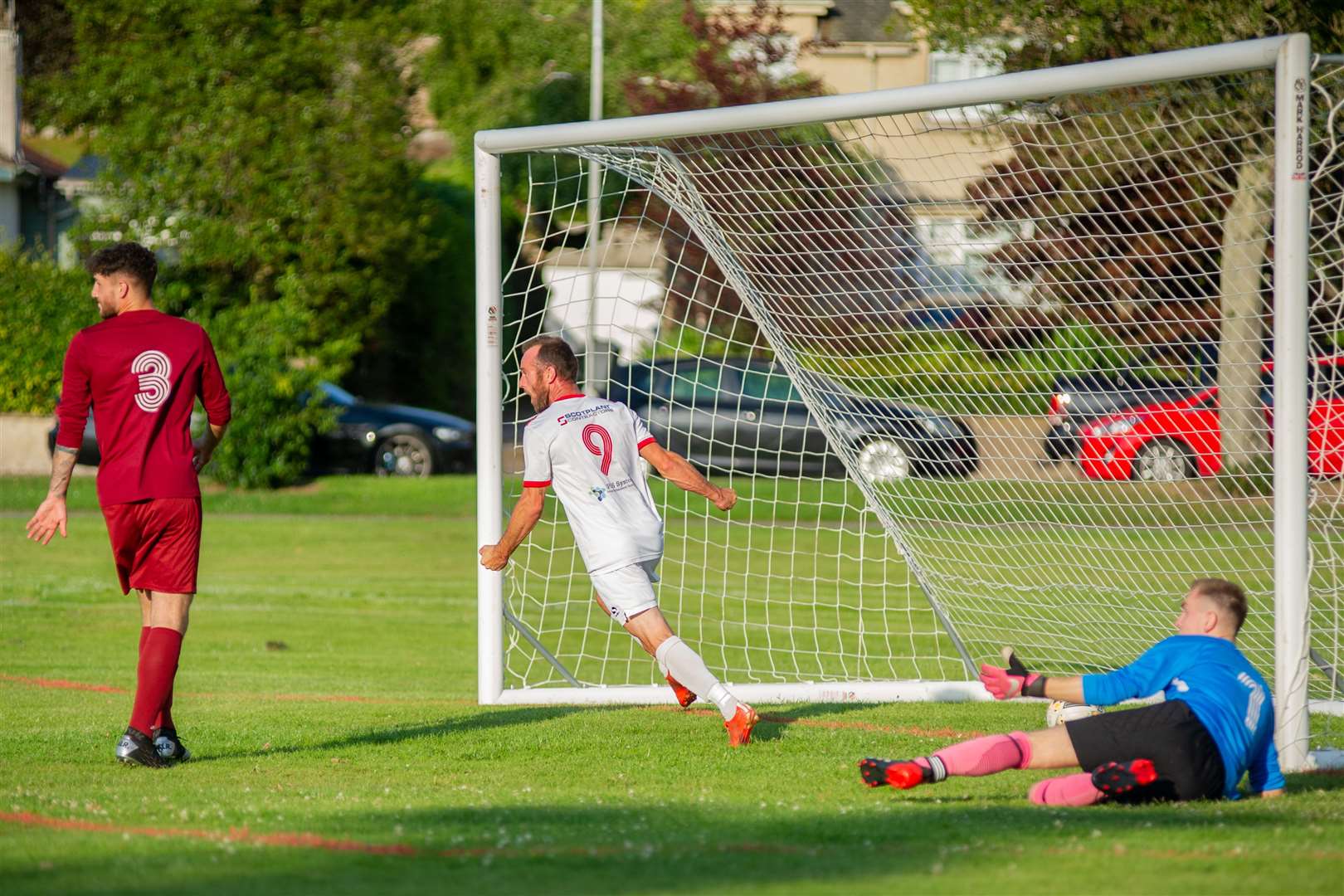 Carisbrooke's Ricky Wardrop scores the only goal of the match past Westerlea's Kyle Mallinson...Carisbrooke FC (1) vs Westerlea FC (0) - Top Car Cup Final - Roysvale, Forres 16/07/2021...Picture: Daniel Forsyth..