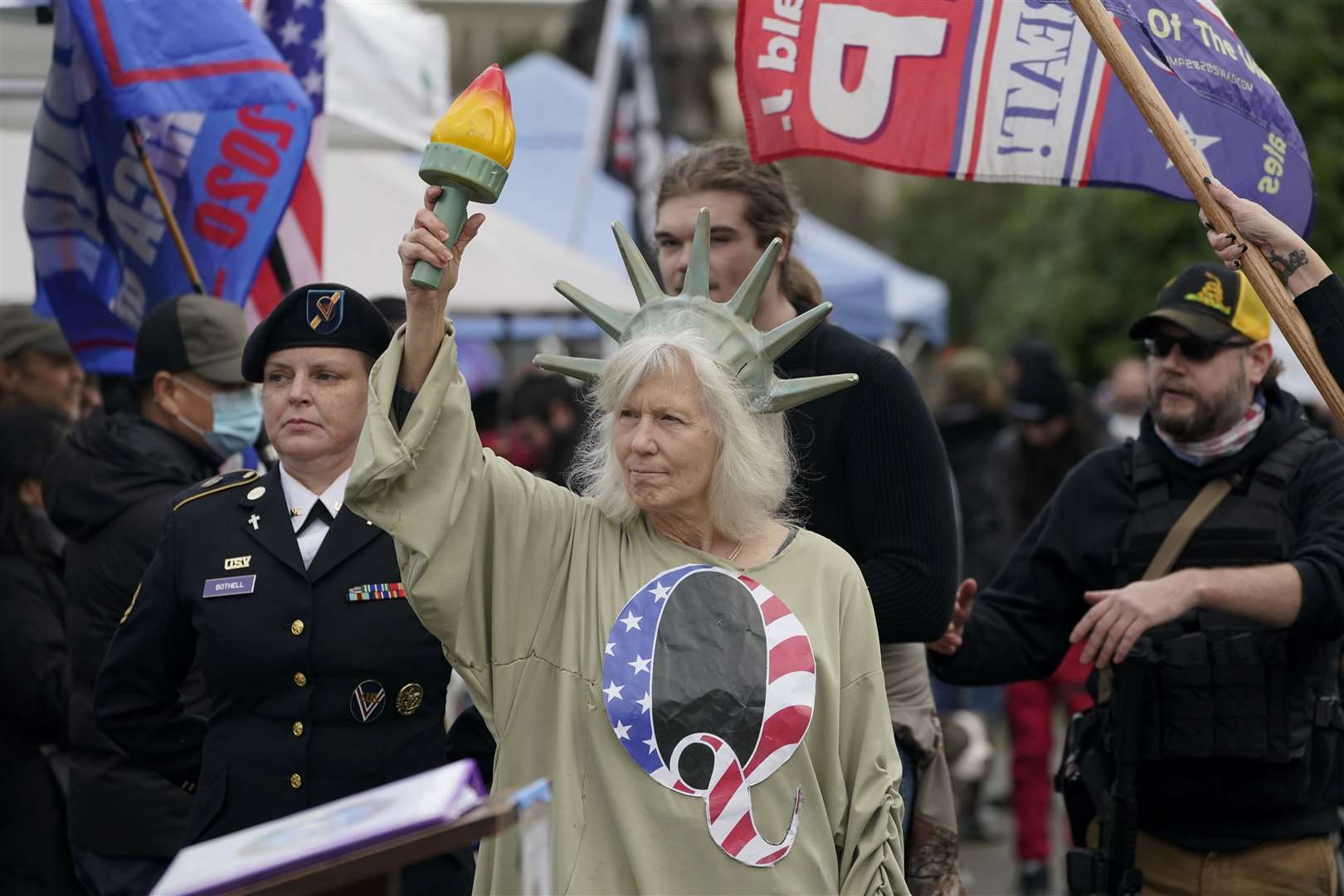 A demonstrator dressed as Lady Liberty wears a shirt with the letter Q, referring to QAnon outside the Capitol building (Ted S. Warren/AP)