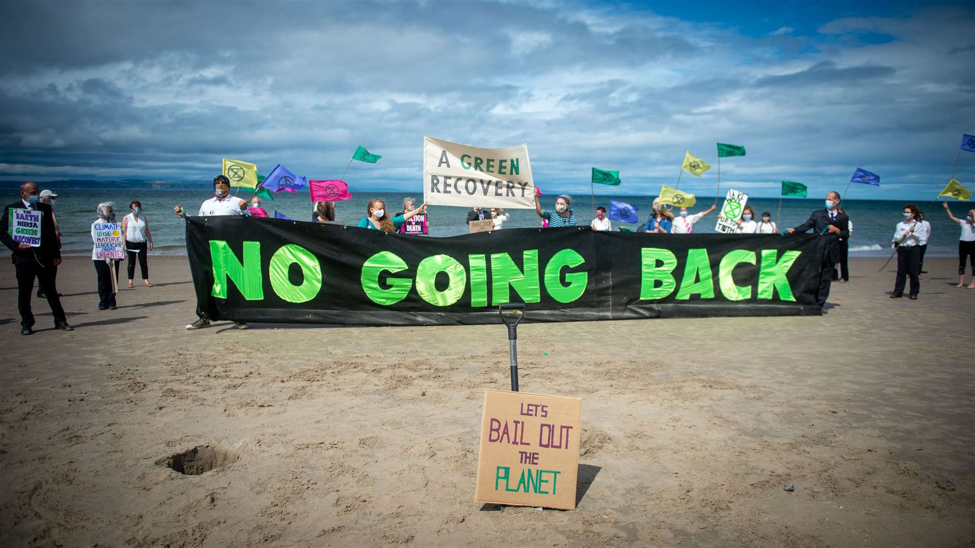 Extinction Rebellion's Head in the Sand action, at Nairn Beach. Picture: Callum Mackay.