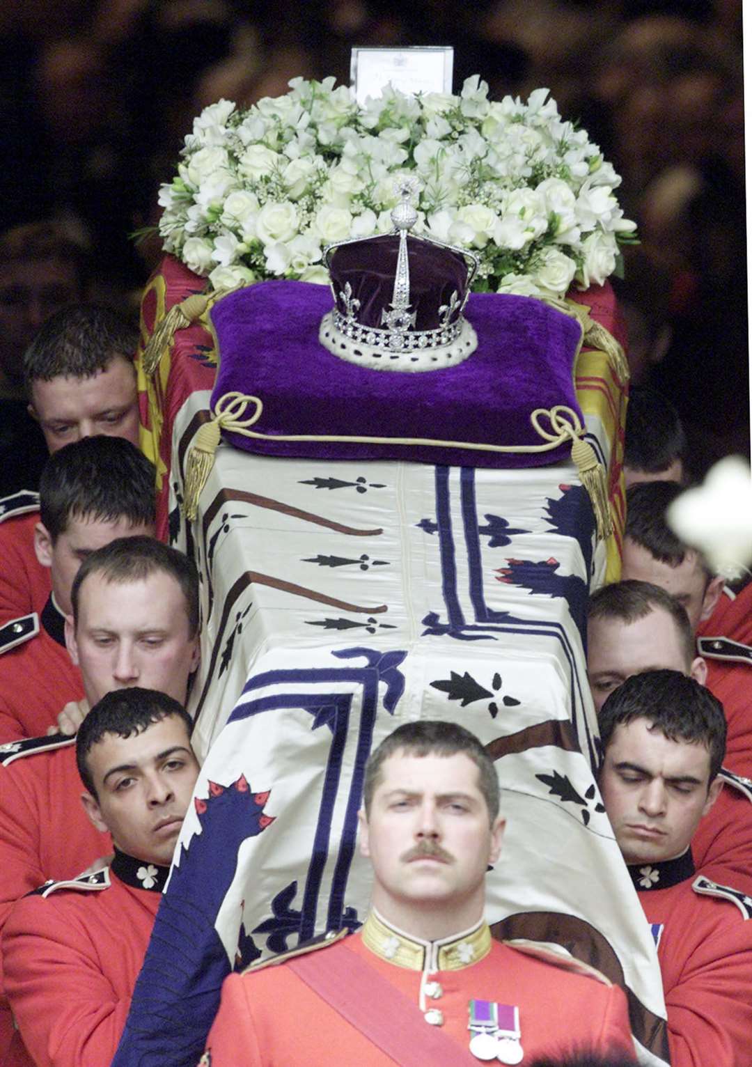 The Queen Mother’s coffin was wrapped in her personal standard, with a wreath of flowers and her coronation crown placed on top (PA)