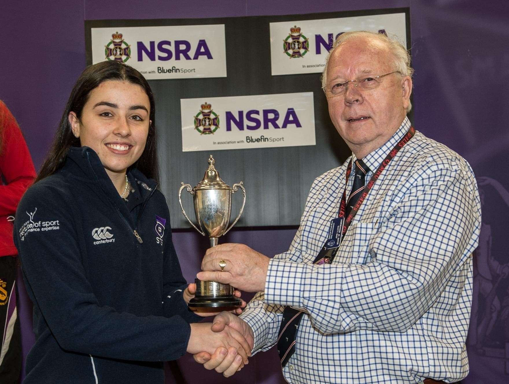 Lucy Evans receives her British junior championship trophy from NRSA chairman John Lloyd.